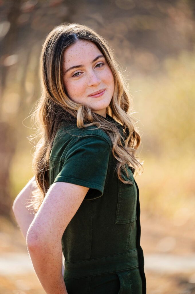 Senior pictures in Edina by Elissa Bean Photography featuring a high school senior looking over her shoulder during an outdoor fall portrait session.